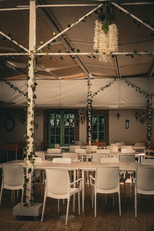 Event tent interior with white chairs setup